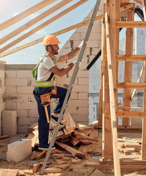 Strong builder working on the construction site